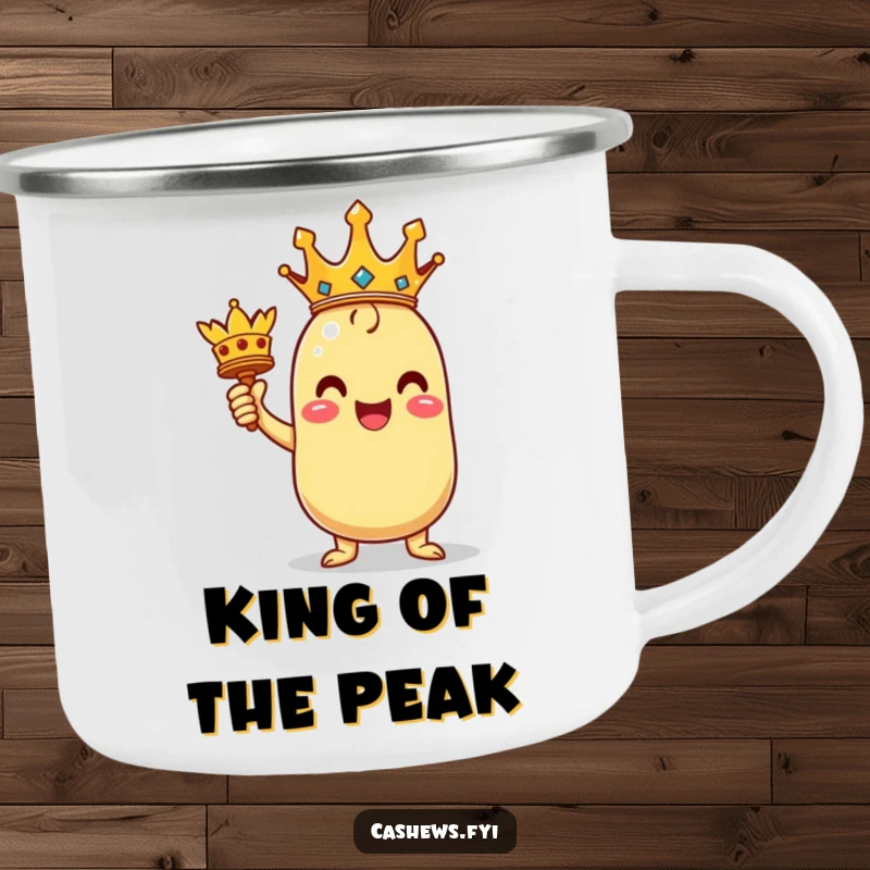 Funny enamel camping mug of a triumphant kawaii cashew character holding a miniature crown, bringing regal outdoor cheer.