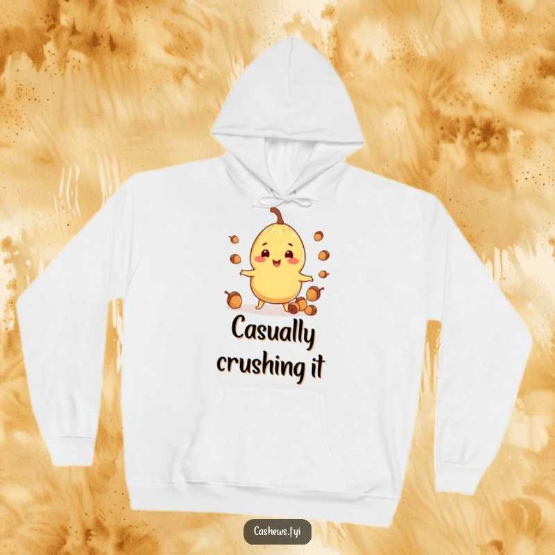Funny hoodie depicting a cashew character in the act of juggling tiny acorns with a joyful and focused expression.
