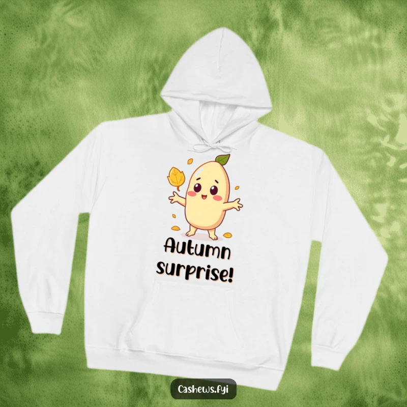 Funny hoodie showing a kawaii cashew startled by a falling leaf, arms outstretched in a comical display of surprise.