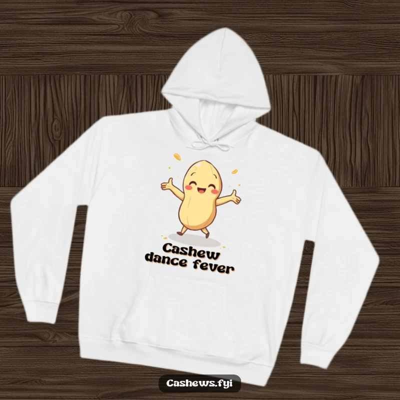 Funny hoodie featuring a cashew doing a delighted jig with arms outstretched and cashew dust swirling, perfect for cozy, energetic vibes.