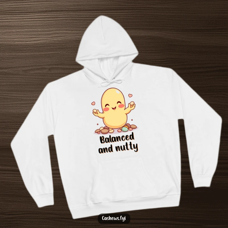 Funny hoodie showcasing a cartoon cashew nut smiling while skillfully juggling tiny pebbles.