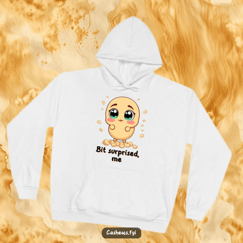 Funny surprised cashew hoodie showing a nut with wide, startled eyes amidst a shower of small cashew bits, offering warmth and humor.
