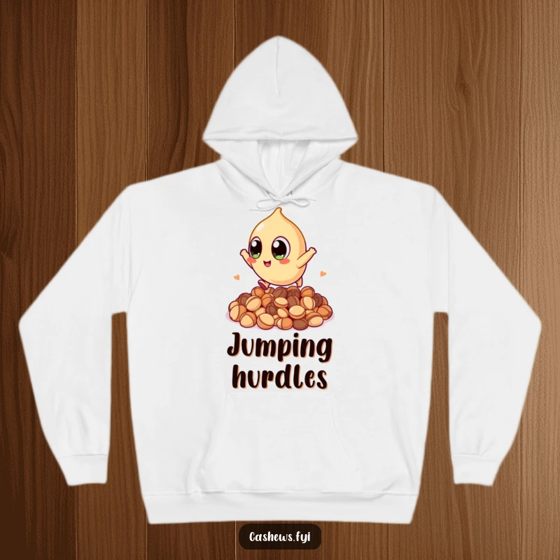 Funny hoodie showcasing a kawaii cashew with huge eyes, leaping over nuts with a determined and happy expression, perfect for cozy fun.